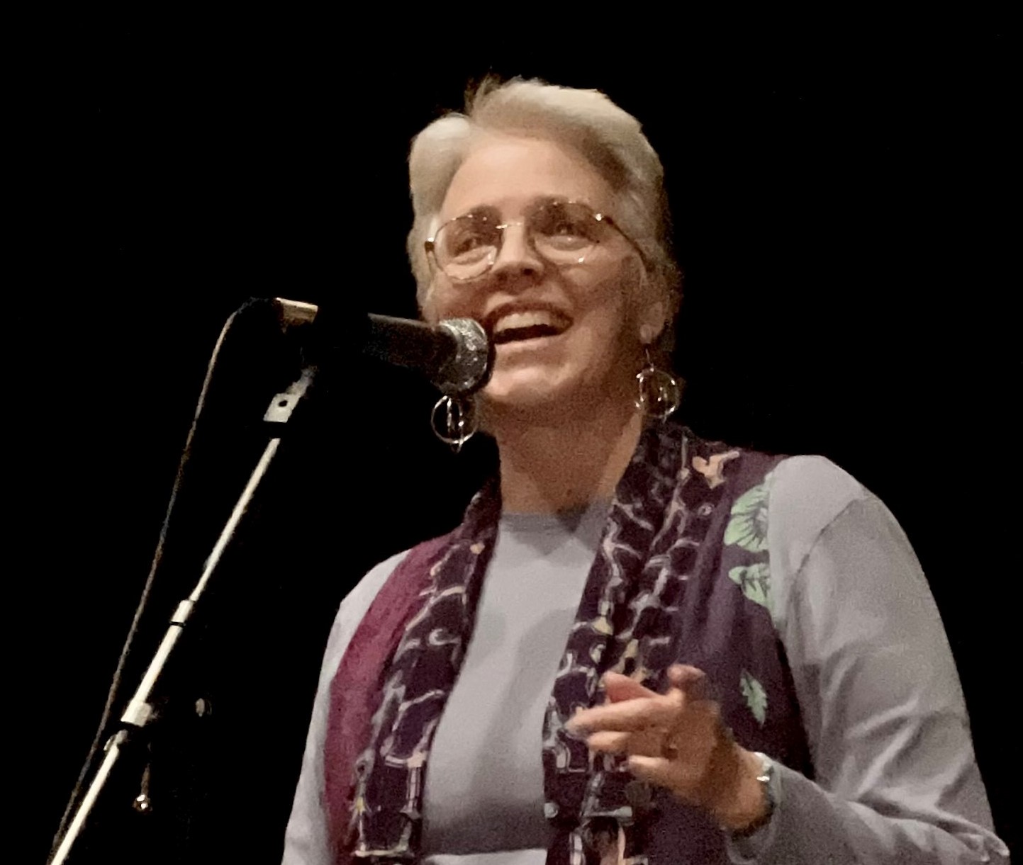 Laura Deal at microphone, telling stories Photo credit Brenton Kirkhart